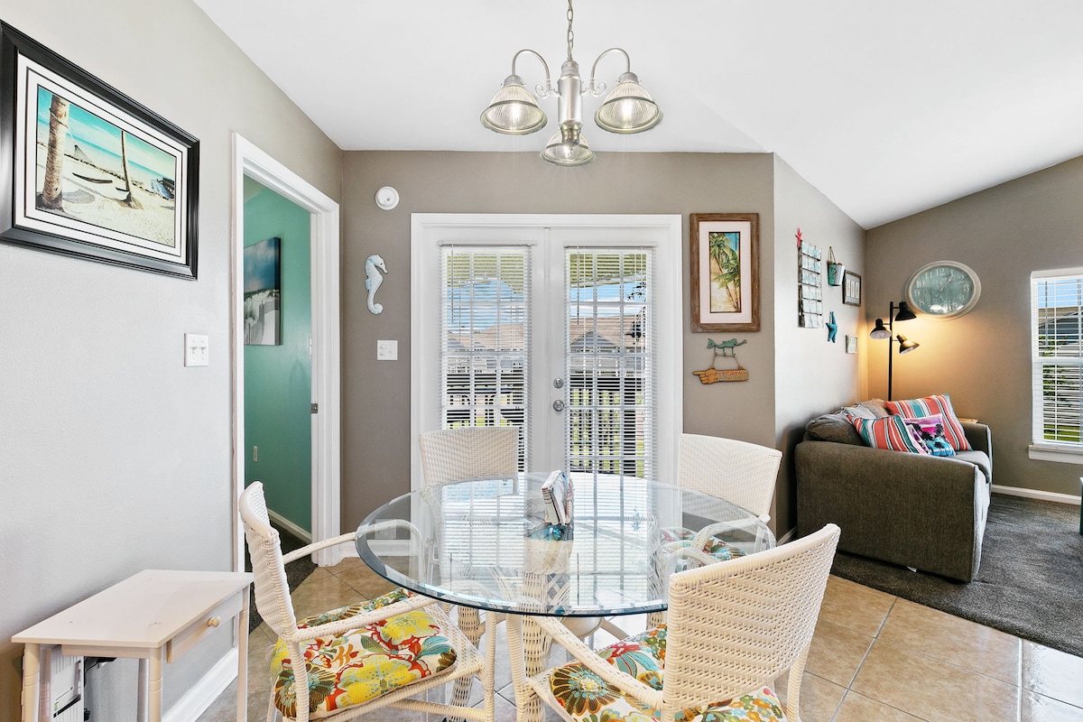 Dining area beside the kitchen and balcony doors.