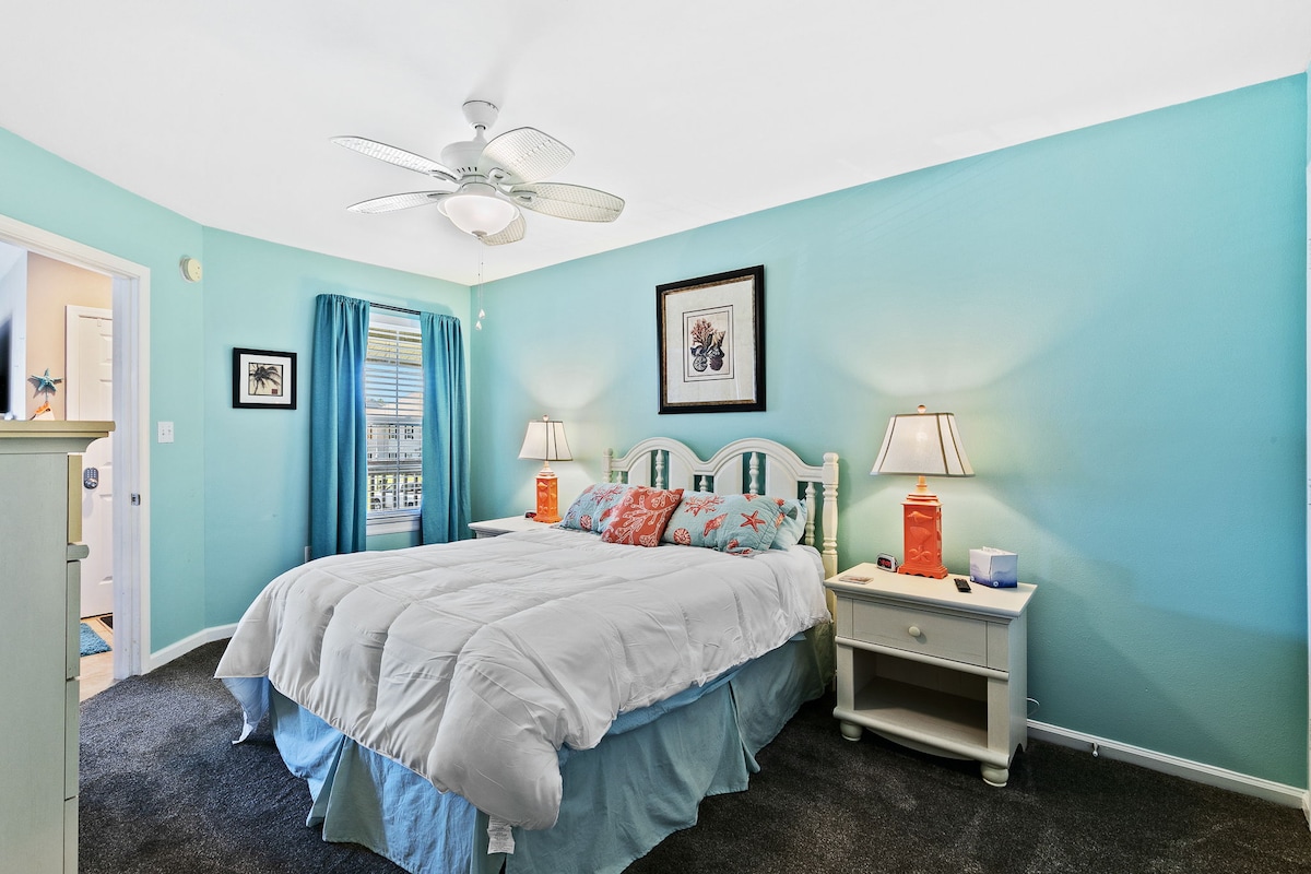 Primary bedroom with a king bed and adjoining bathroom.
